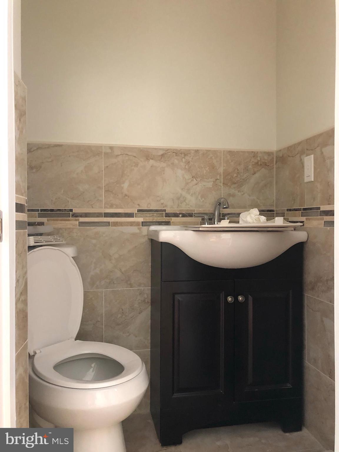 7703 Parkview Road Upper Darby, PA 19082 - Photo 11 of 30 a bathroom with a sink toilet and a mirror