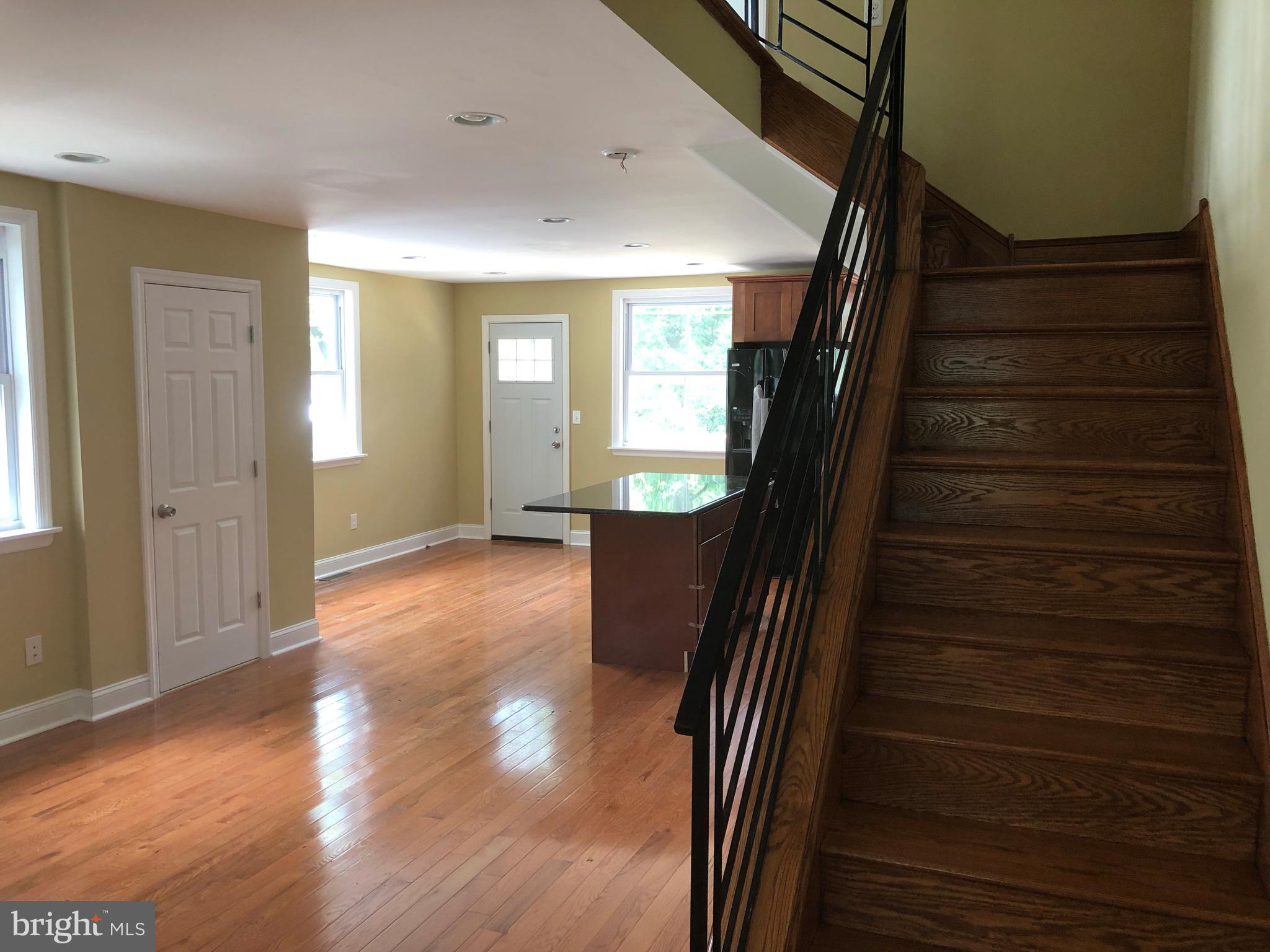 7703 Parkview Road Upper Darby, PA 19082 - Photo 18 of 30 a view of a hallway with wooden floor and stairs