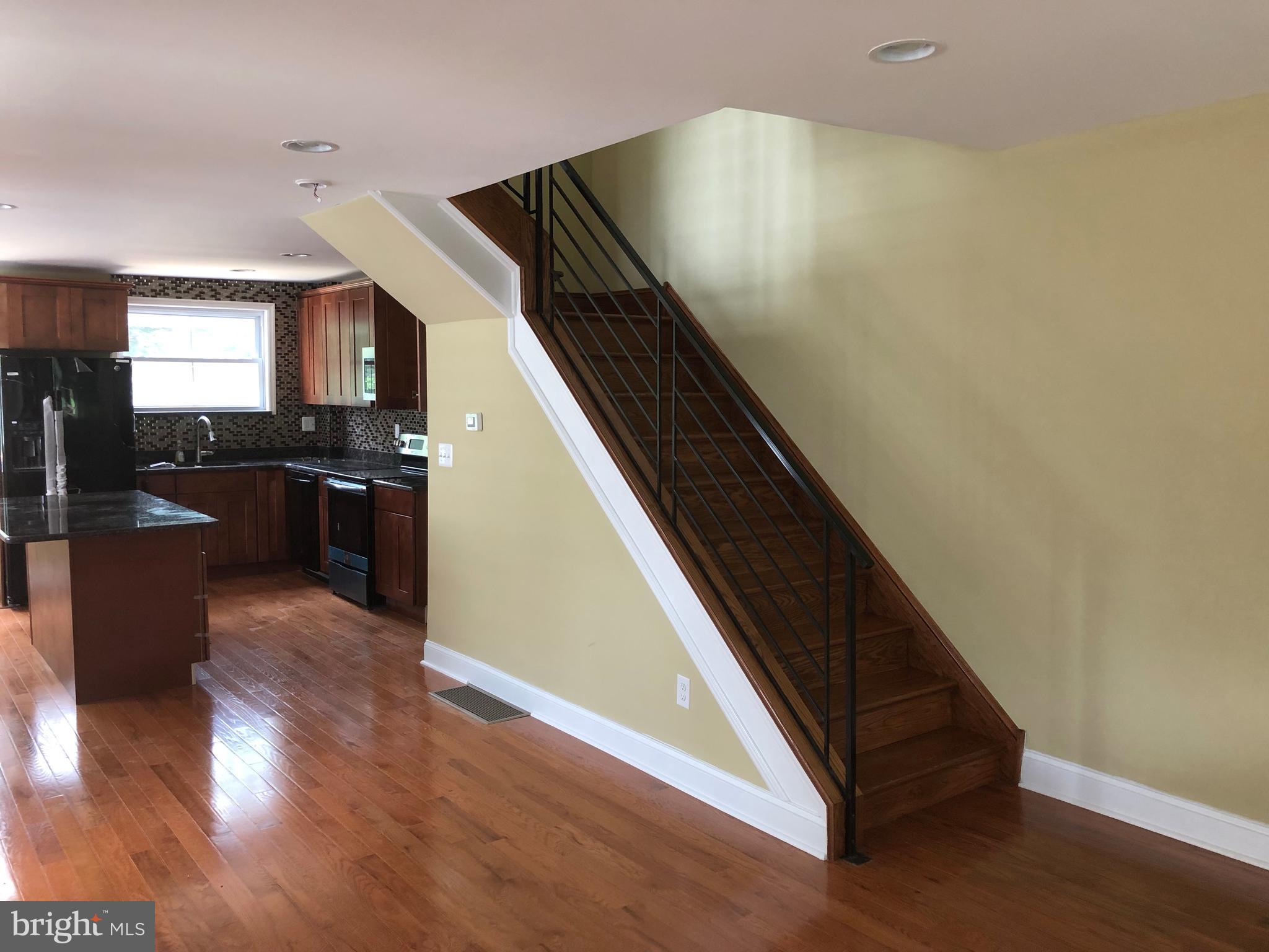 7703 Parkview Road Upper Darby, PA 19082 - Photo 3 of 30 a view of a living room with wooden floor and stainless steel appliances