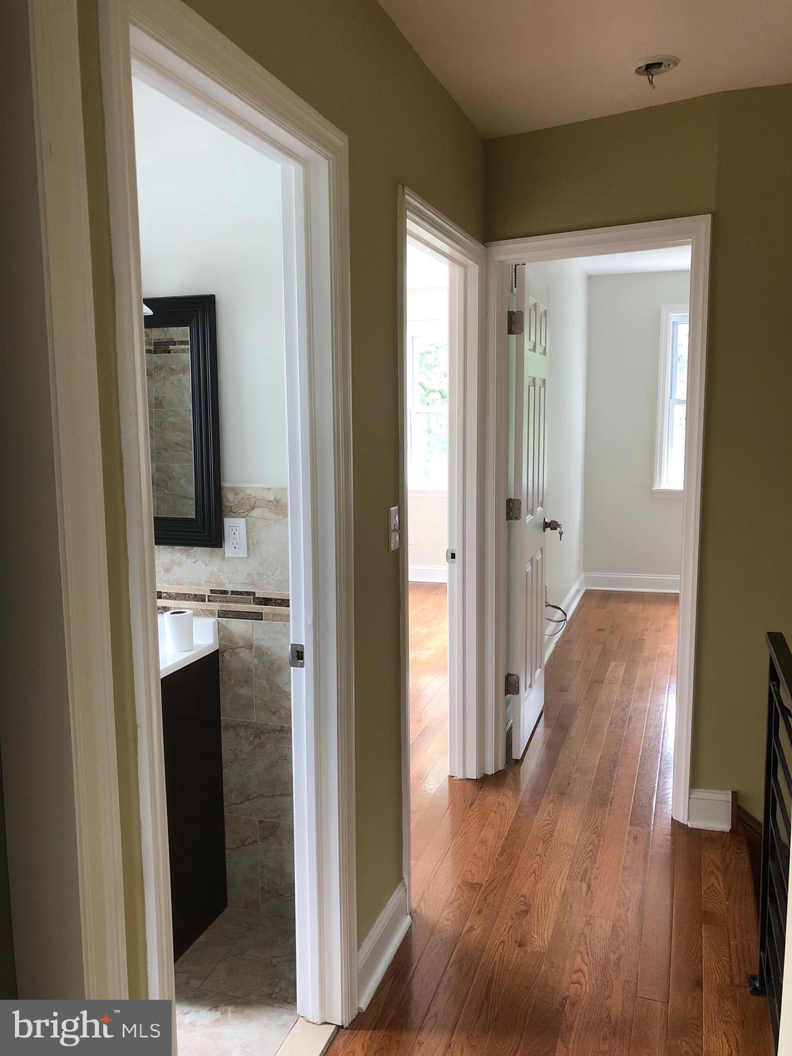 7703 Parkview Road Upper Darby, PA 19082 - Photo 22 of 30 a view of a hallway with wooden floor and closet area