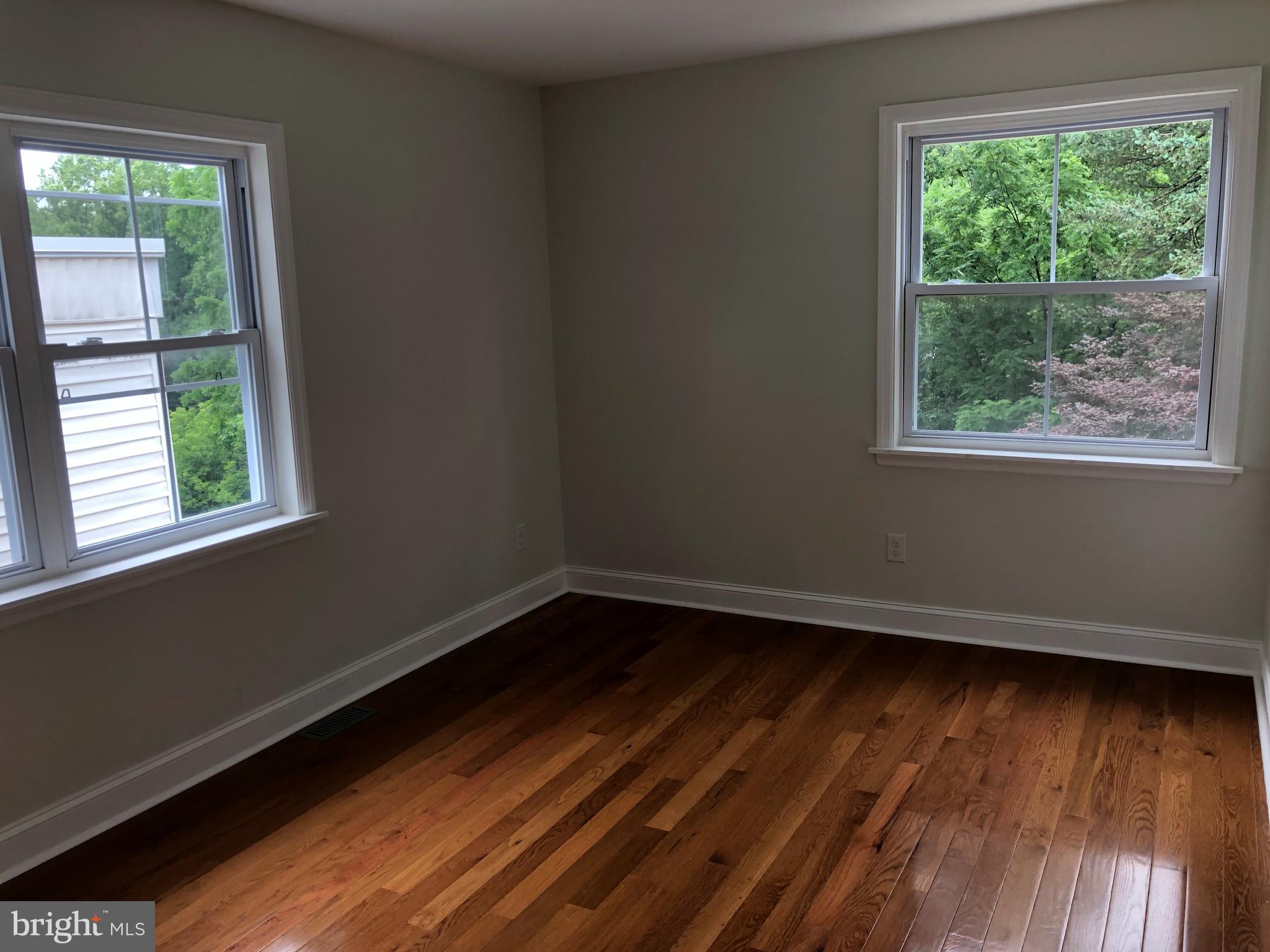 7703 Parkview Road Upper Darby, PA 19082 - Photo 28 of 30 a view of an empty room with wooden floor and a window