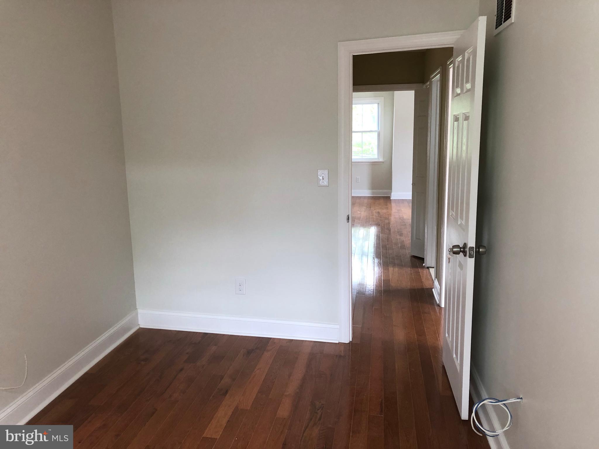 7703 Parkview Road Upper Darby, PA 19082 - Photo 29 of 30 a view of a hallway with wooden floor