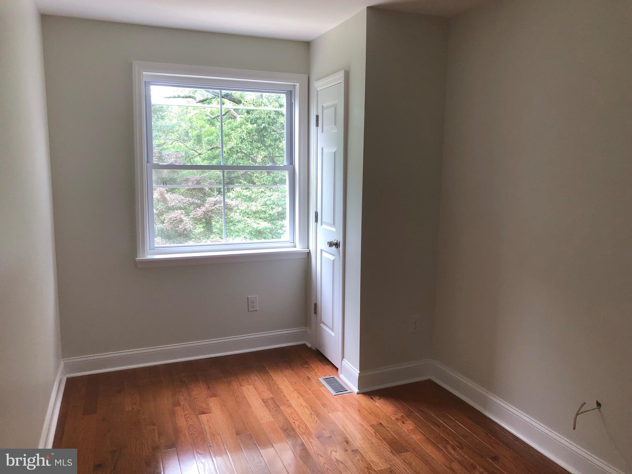 7703 Parkview Road Upper Darby, PA 19082 - Photo 30 of 30 an empty room with wooden floor and windows
