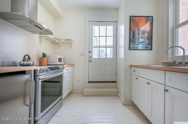 a kitchen with cabinets and window