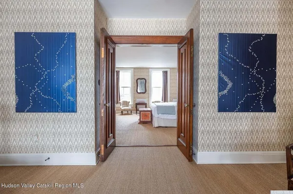 a view of a bedroom from a hallway