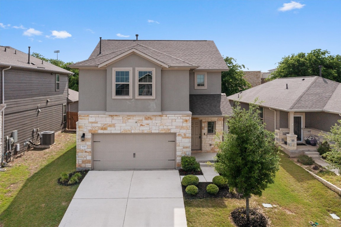 a front view of a house with garden