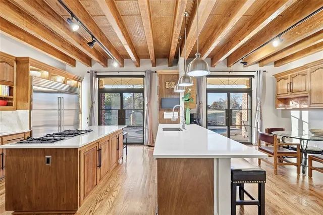 a kitchen with a stove and wooden cabinets