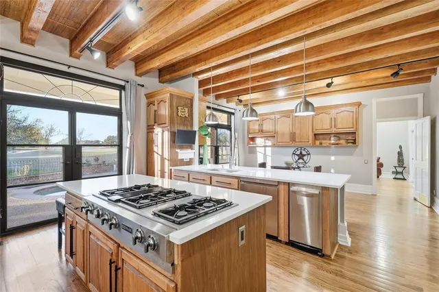 a kitchen with stainless steel appliances granite countertop a stove and a sink