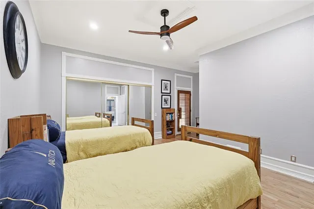 a bedroom with a bed and wooden floor