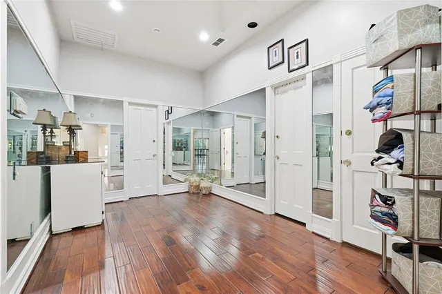 wooden floor with a dining table chairs and chandelier