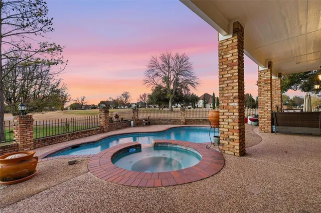 a view of a house with swimming pool and sitting area