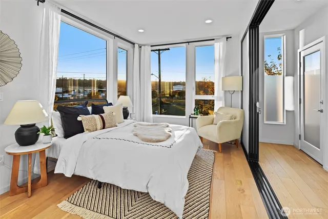 a bedroom with a large bed and a large window