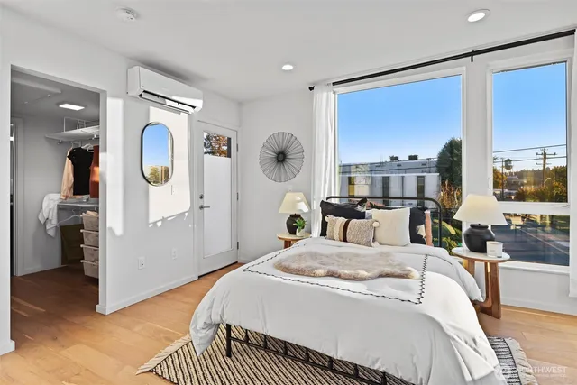 a bedroom with a bed and a dresser with mirror