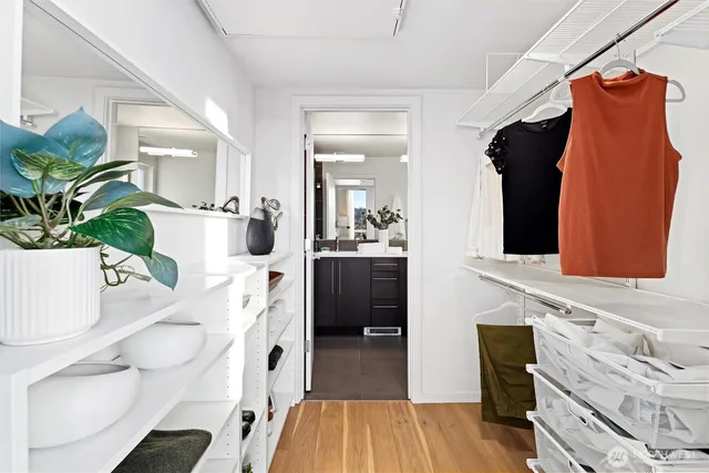 a view of walk in closet with clothes and shoes