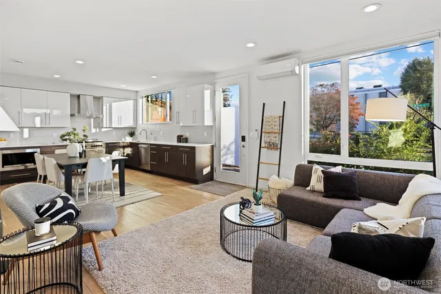 a living room with furniture potted plant and large windows