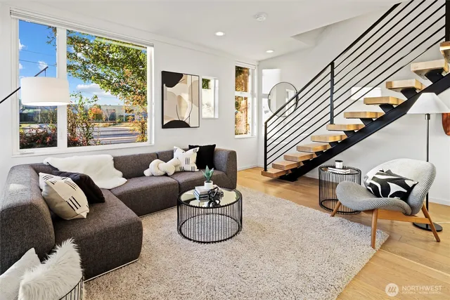 a living room with furniture or couch and a floor to ceiling window