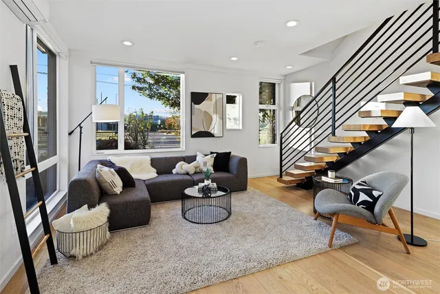 a living room with furniture and wooden floor