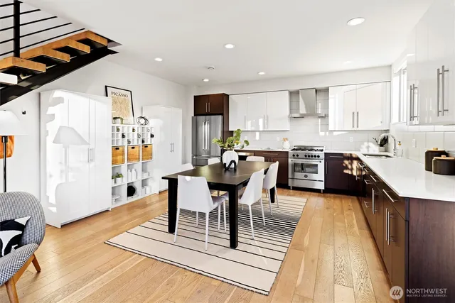 a large kitchen with stainless steel appliances microwave refrigerator and a stove top oven