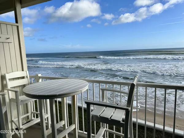 a view of a balcony with furniture