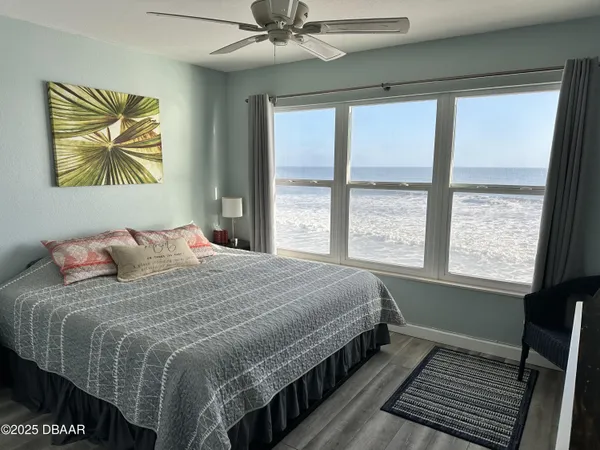 a bedroom with a bed and a large window