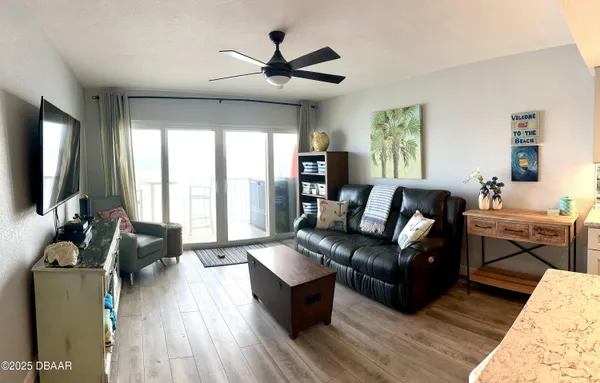 a living room with furniture flat screen tv and window