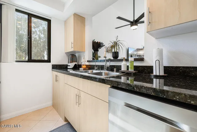a kitchen with a sink and a window