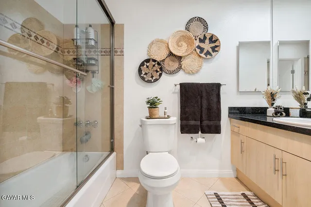 a bathroom with a sink a toilet and a shower