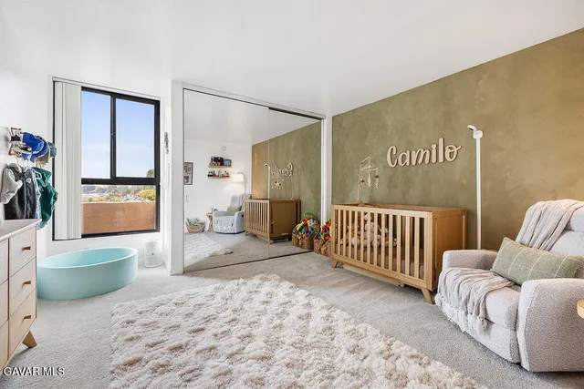 a spacious bedroom with a bed and a couch