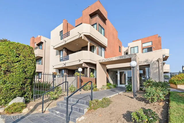 front view of a brick house with large windows