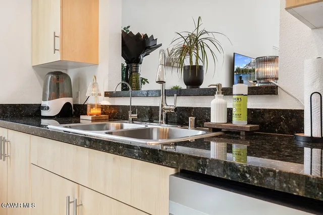 a kitchen with a sink and a white cabinets