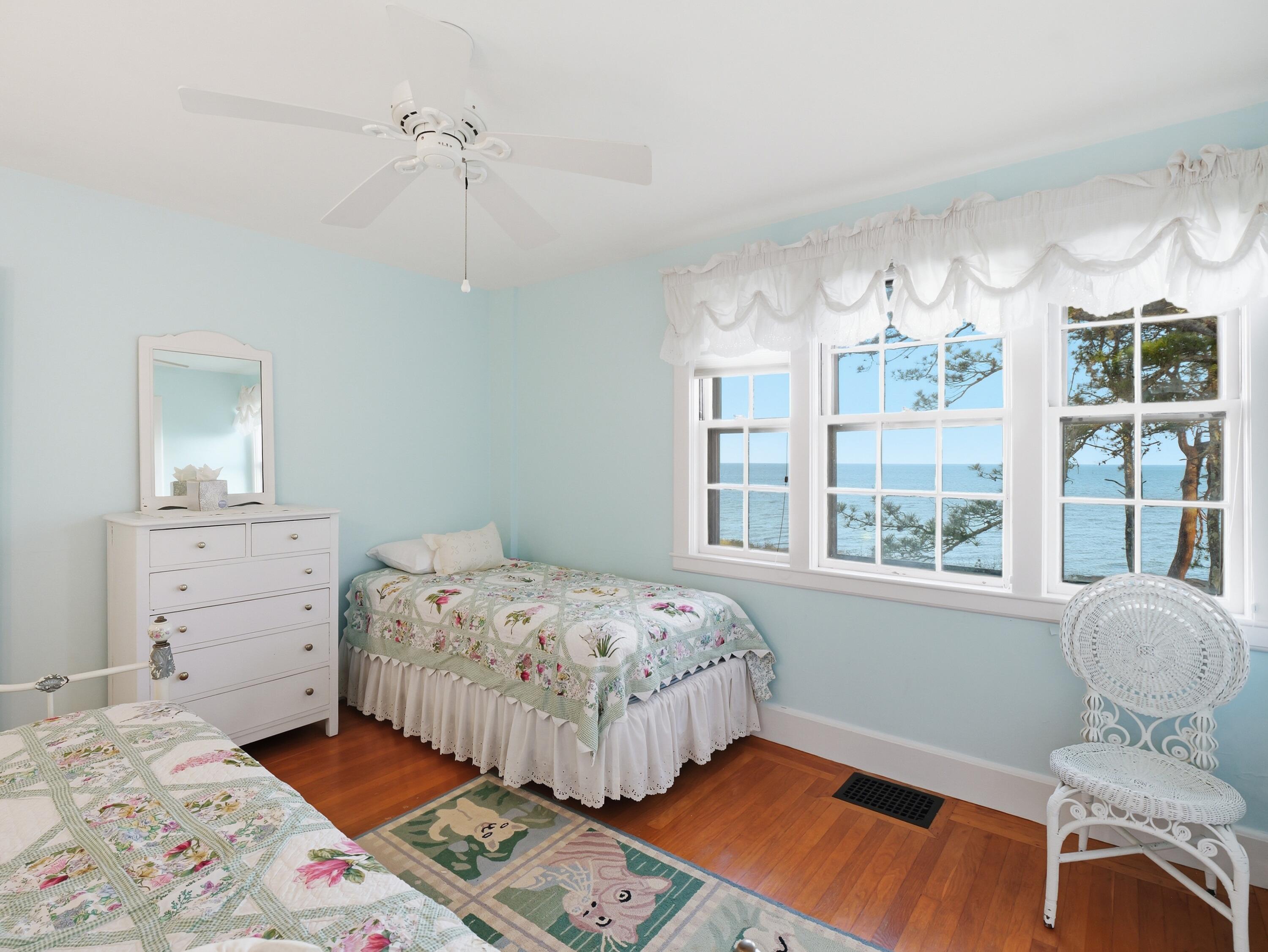190 Vineyard Road Cotuit, MA 02635 - Photo 27 of 41 a bedroom with a bed and wooden floor