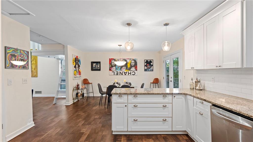495 Ramsdale Drive Roswell, GA 30075 - Photo 12 of 32 a kitchen that has a lot of cabinets in it and wooden floors