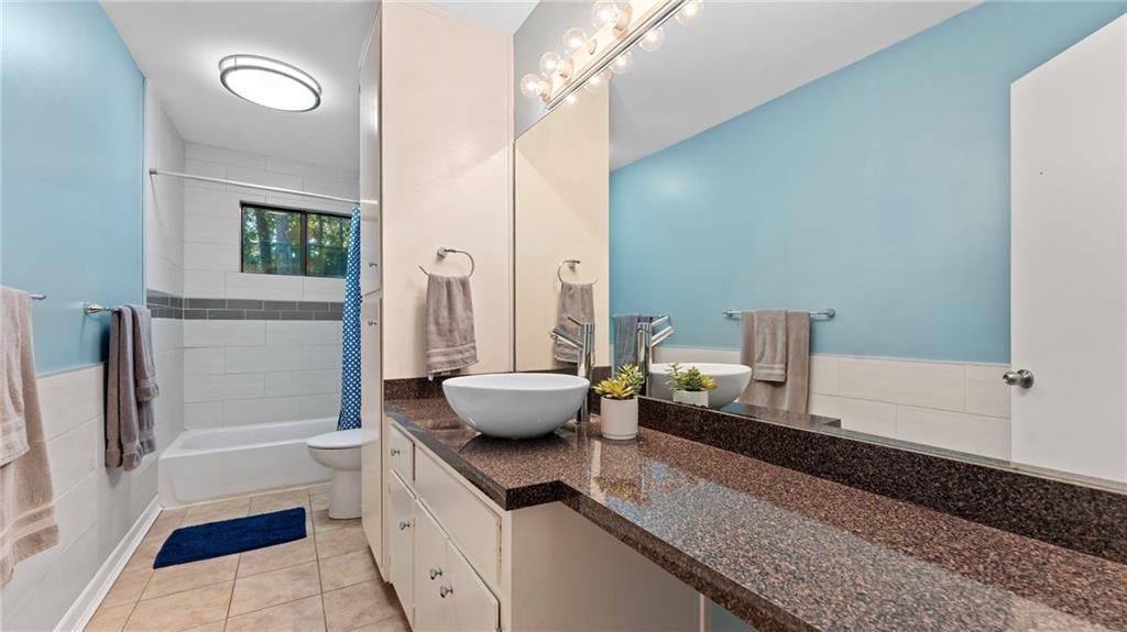 495 Ramsdale Drive Roswell, GA 30075 - Photo 13 of 32 a spacious bathroom with a granite countertop sink and a mirror