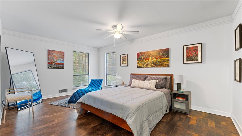 495 Ramsdale Drive Roswell, GA 30075 - Photo 14 of 32 a bedroom with a bed and a chandelier