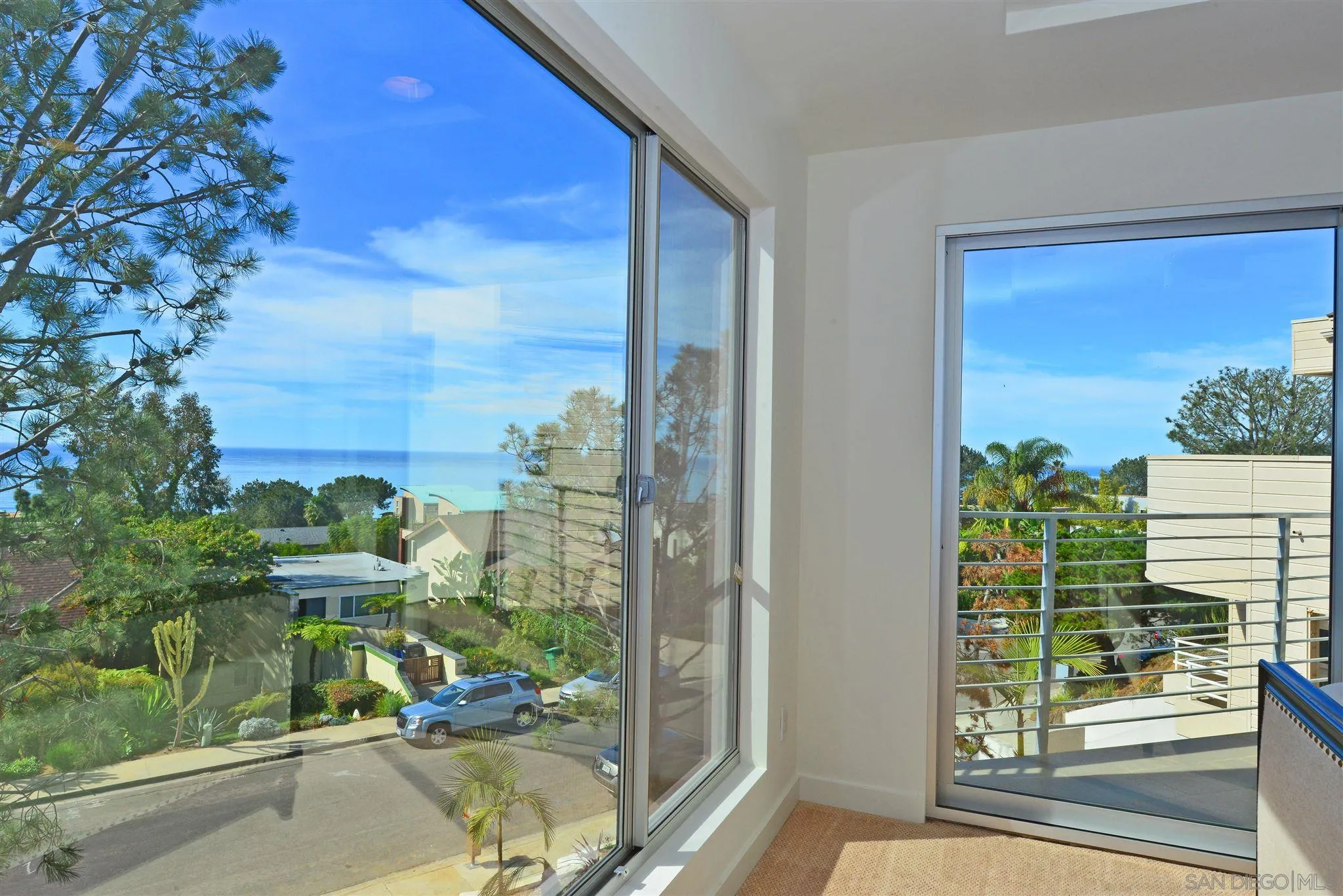 13721 Pine Needles Drive Del Mar, CA 92014 - Photo 2 of 32 a view of a porch with a floor to ceiling window and wooden fence