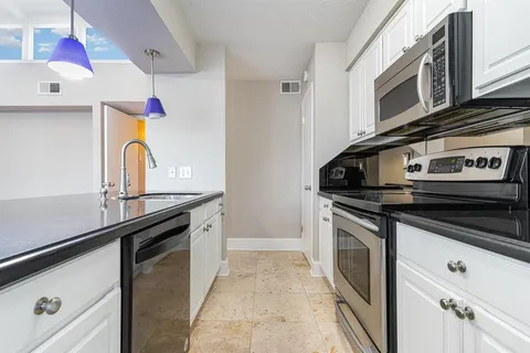 a kitchen with stainless steel appliances granite countertop a stove and a sink
