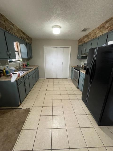 3071 Auburn Road Crestview, FL 32539 - Photo 9 of 21 a kitchen with a sink a stove and a refrigerator