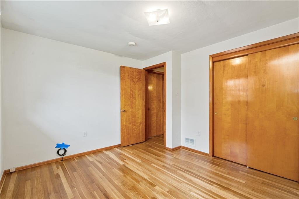 109 Marshall Drive Moon Township, PA 15108 - Photo 15 of 25 a view of an empty room with wooden floor and a window
