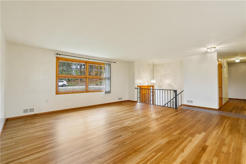 109 Marshall Drive Moon Township, PA 15108 - Photo 2 of 25 a view of an empty room with window and wooden floor