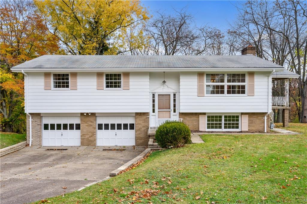 109 Marshall Drive Moon Township, PA 15108 - Photo 25 of 25 a view of a white house with large windows and a yard with plants