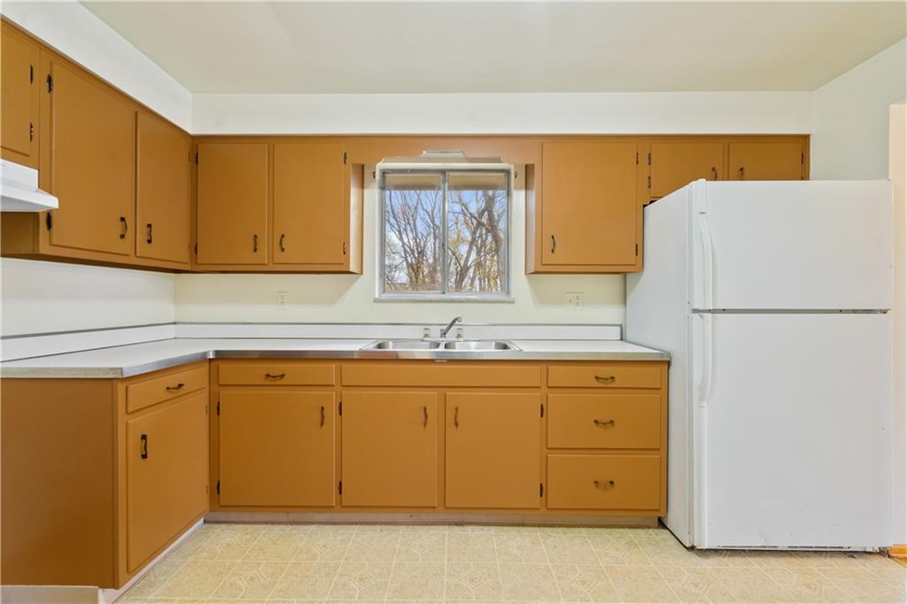 109 Marshall Drive Moon Township, PA 15108 - Photo 8 of 25 a kitchen with granite countertop a sink and a refrigerator