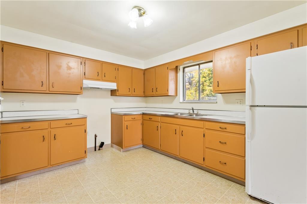 109 Marshall Drive Moon Township, PA 15108 - Photo 9 of 25 a kitchen with granite countertop cabinets stainless steel appliances a sink and a window