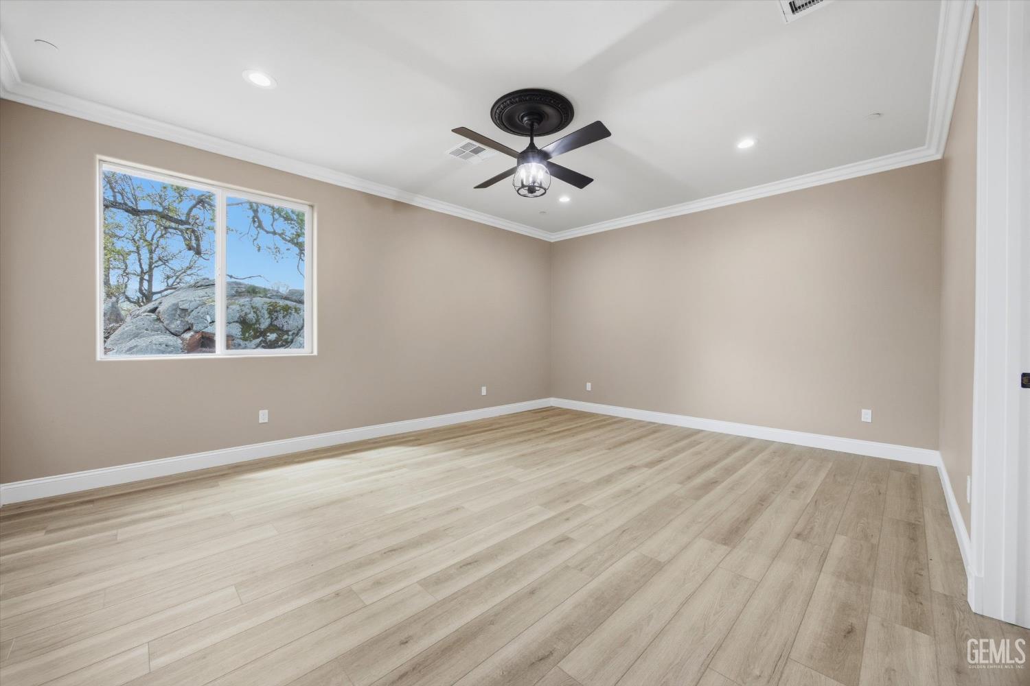 Undisclosed Address Tehachapi, CA 93561 - Photo 30 of 47 a view of an empty room with wooden floor and a ceiling fan
