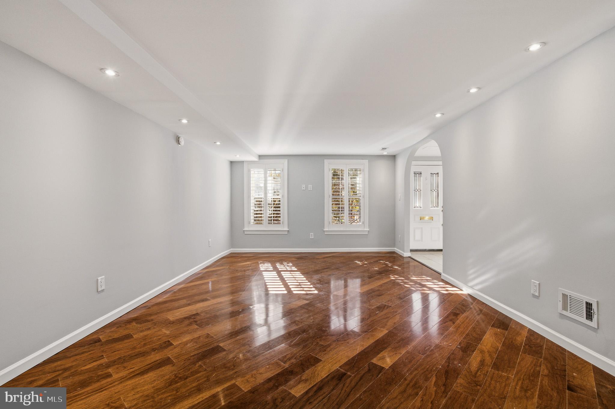 2117 S Street Northwest Washington, DC 20008 - Photo 28 of 63 a view of an empty room with wooden floor and a window