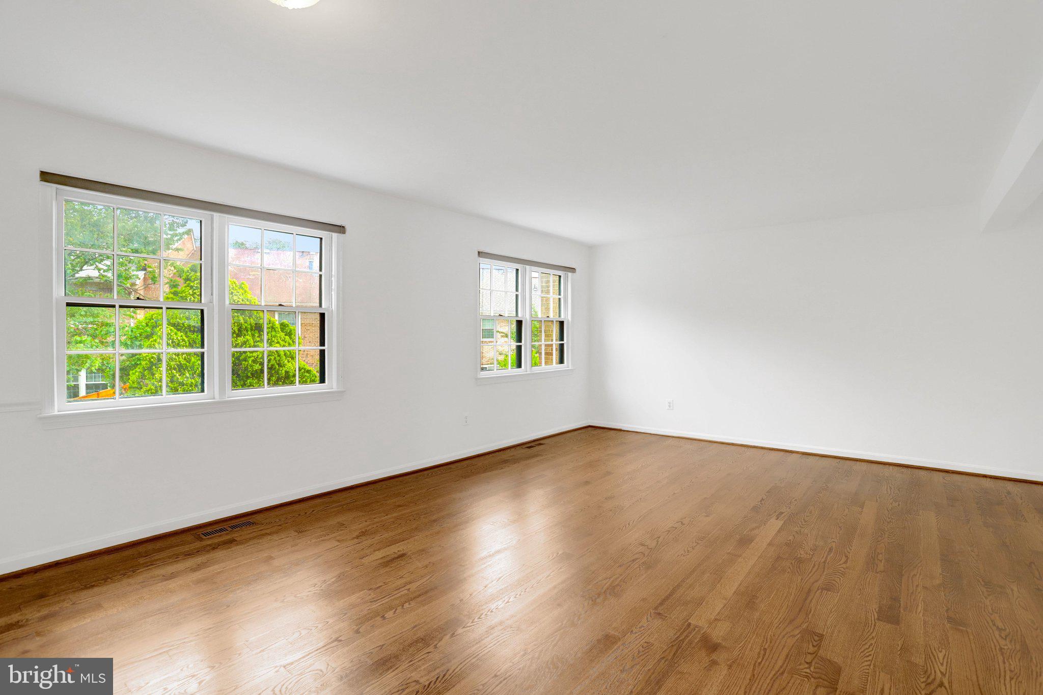 2225 North Tuckahoe Street Arlington, VA 22205 - Photo 6 of 37 a view of an empty room with wooden floor and a window