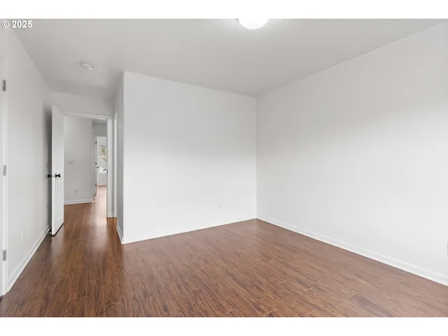 a view of an empty room and wooden floor