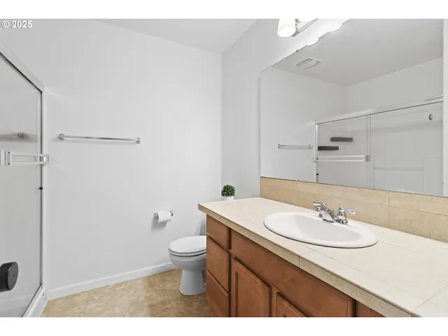 a bathroom with a sink toilet and a mirror