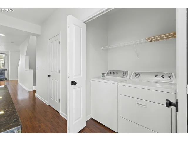 a view of storage and utility room with wooden floor
