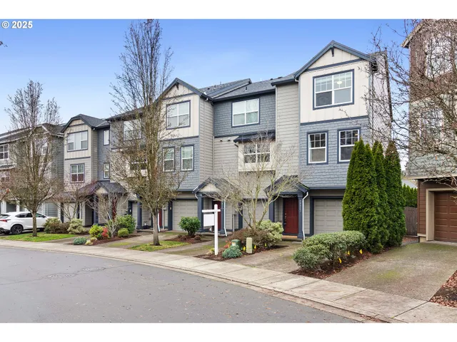 a front view of a residential apartment building with a yard