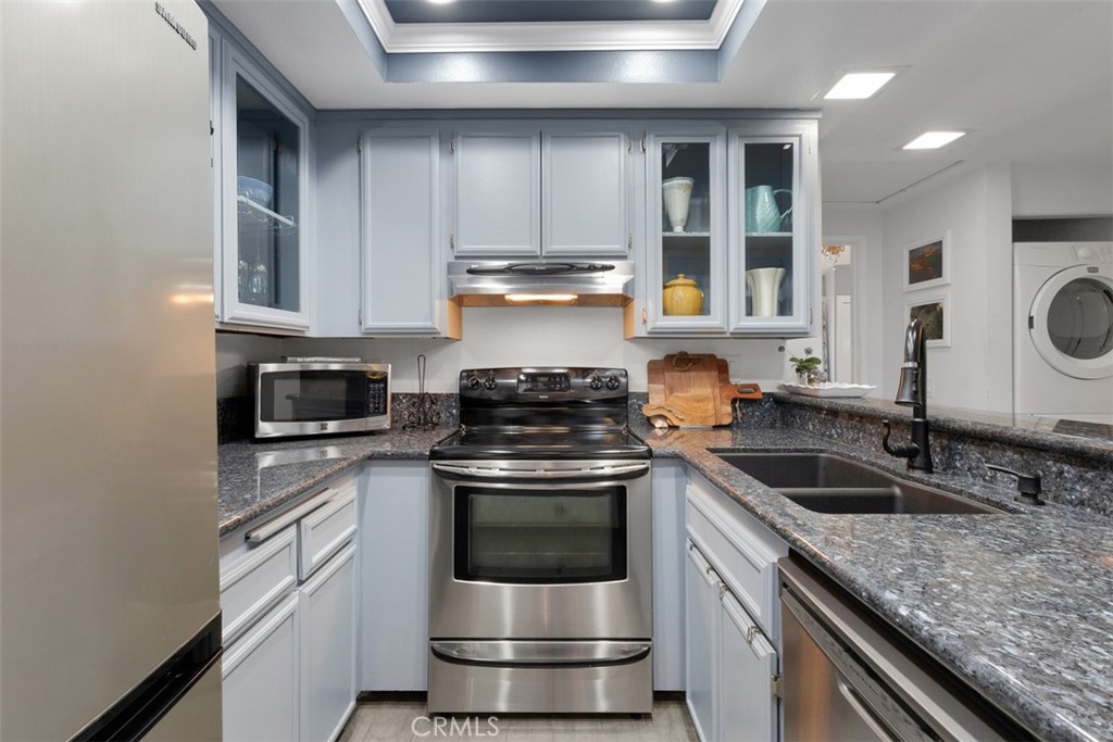 2713 Quail Ridge Circle, Unit 25 Fullerton, CA 92835 - Photo 13 of 30 a kitchen with stainless steel appliances granite countertop a stove and a sink
